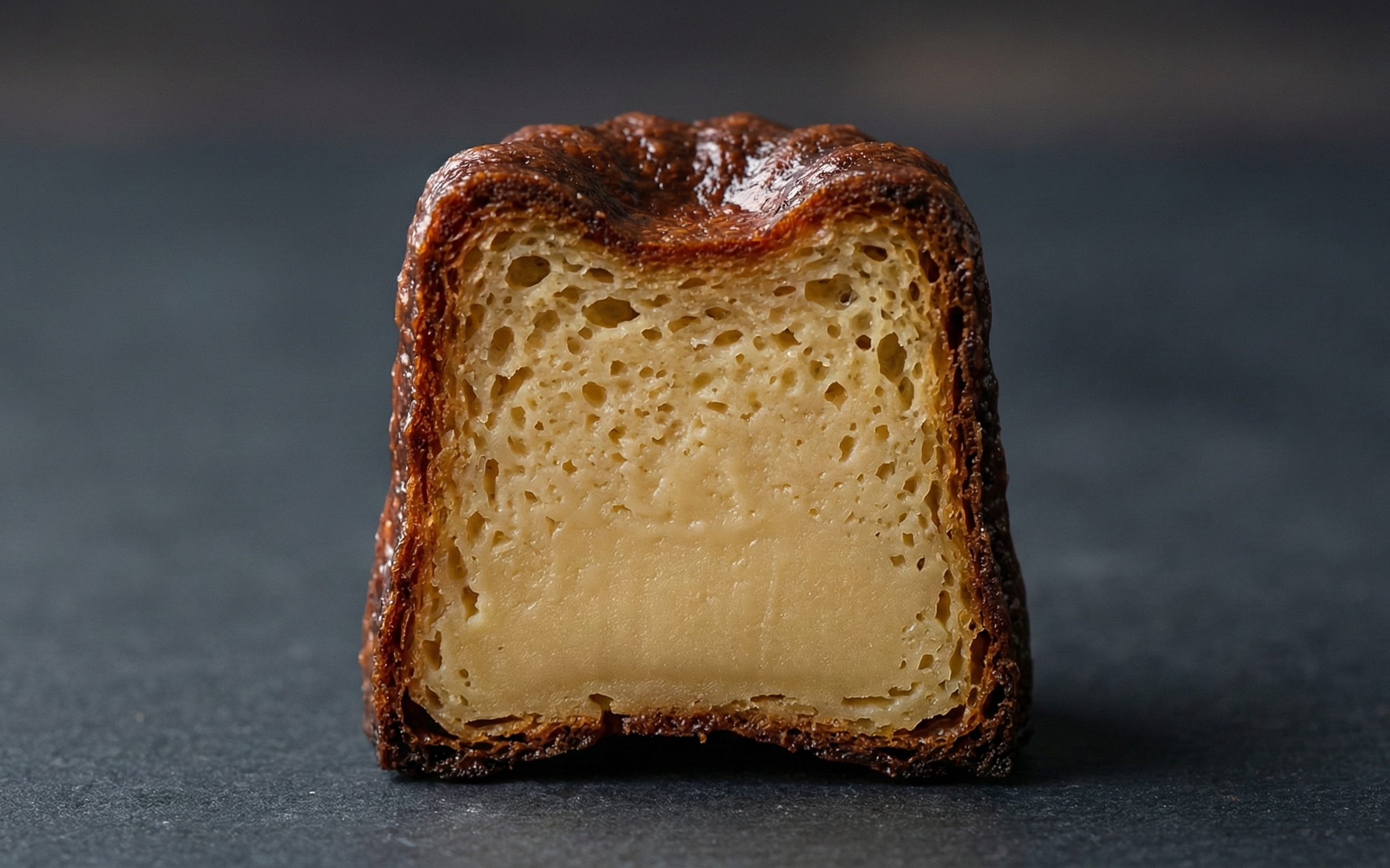 米粉カヌレの断面：上部にわずかな気泡があり、下に向かって濃密なカスタードのような見た目